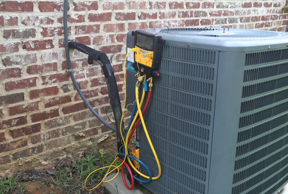 Maintenance being performed on an air conditioner. Highlighting the importance of cooling system maintenance benefits for efficient performance. Contact us for AC maintenance near me in St Maries, Athol, and Blanchard, ID. Professional electrician and HVAC technician near me. Contact us to schedule an appointment for ac service near me in Coeur d'Alene, CDA, Post Falls, Hayden, Rathdrum, Sandpoint, Spirit Lake, St Maries, Athol, Blanchard, Dalton Gardens, Worley, Plummer, or Harrison, ID. Expert assistance for air conditioning tune up ac repair, maintenance and installation. Contact J.A. Bertsch Heating and Cooling today for ac services!