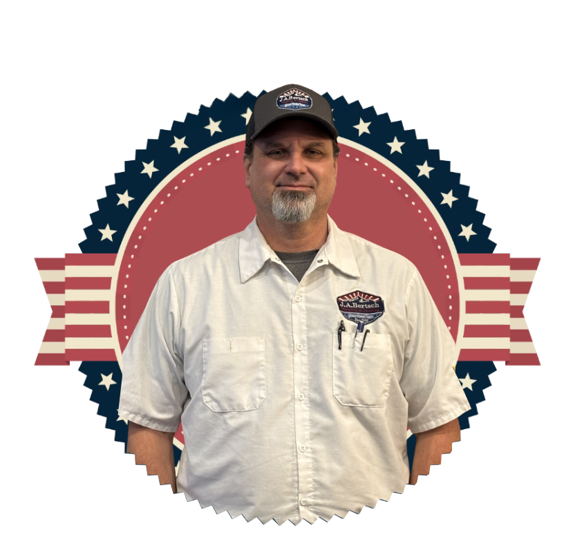 Barret, a friendly HVAC technician in a white shirt, smiles in front of the J.A. Bertsch logo.
