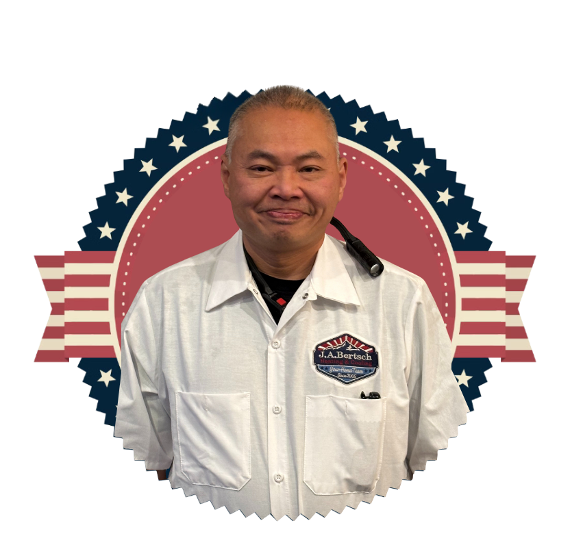 Dan, a friendly HVAC technician in a white shirt, smiles in front of the J.A. Bertsch logo.