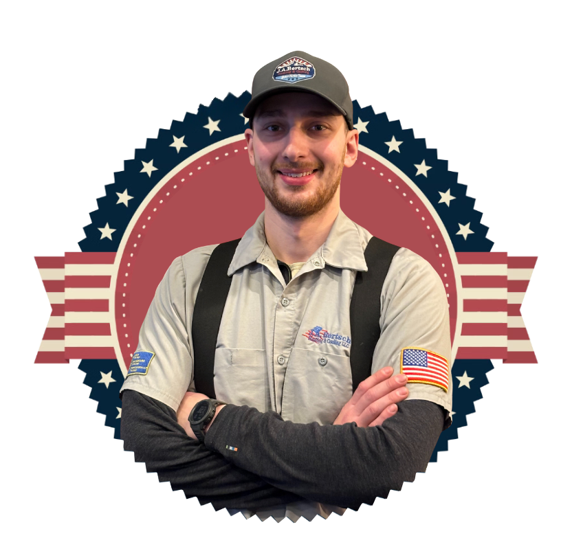 Greg, a friendly HVAC technician in grey shirt and overalls, smiles in front of a J.A. Bertsch logo.